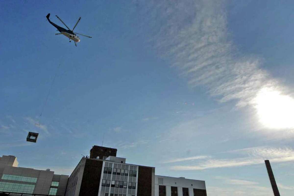 ?A construction helicopter lifts a large air-handling unit onto the roof of St. Peter's Hospital in Albany, New York 8/14/2010. ( Michael P. Farrell / Times Union )