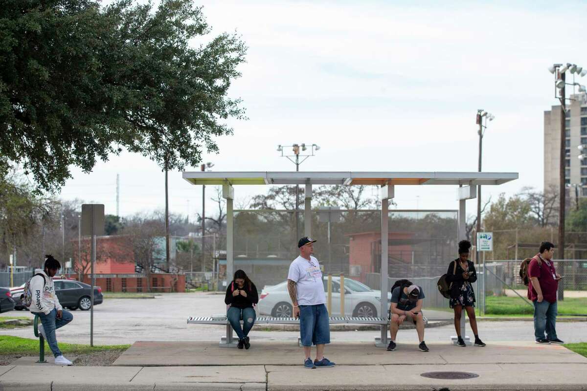 wait for their bus at VIA bus stop on San Pedro Avenue and West Myrtle Street last week.