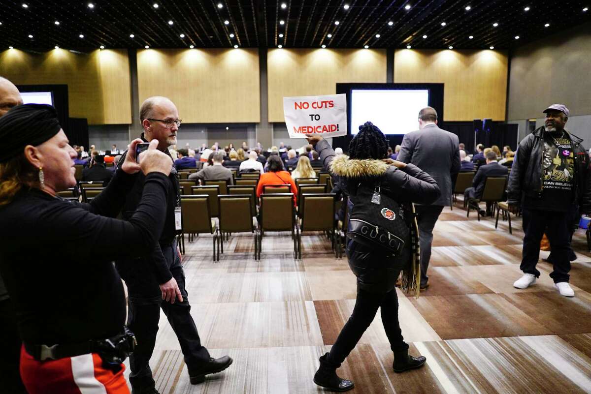 Protesters disrupt the first meeting of the Medicaid redesign team at the Albany Capital Center on Tuesday, Feb. 11, 2020, in Albany, N.Y. The protesters were ultimately escorted out of the meeting. (Paul Buckowski/Times Union)