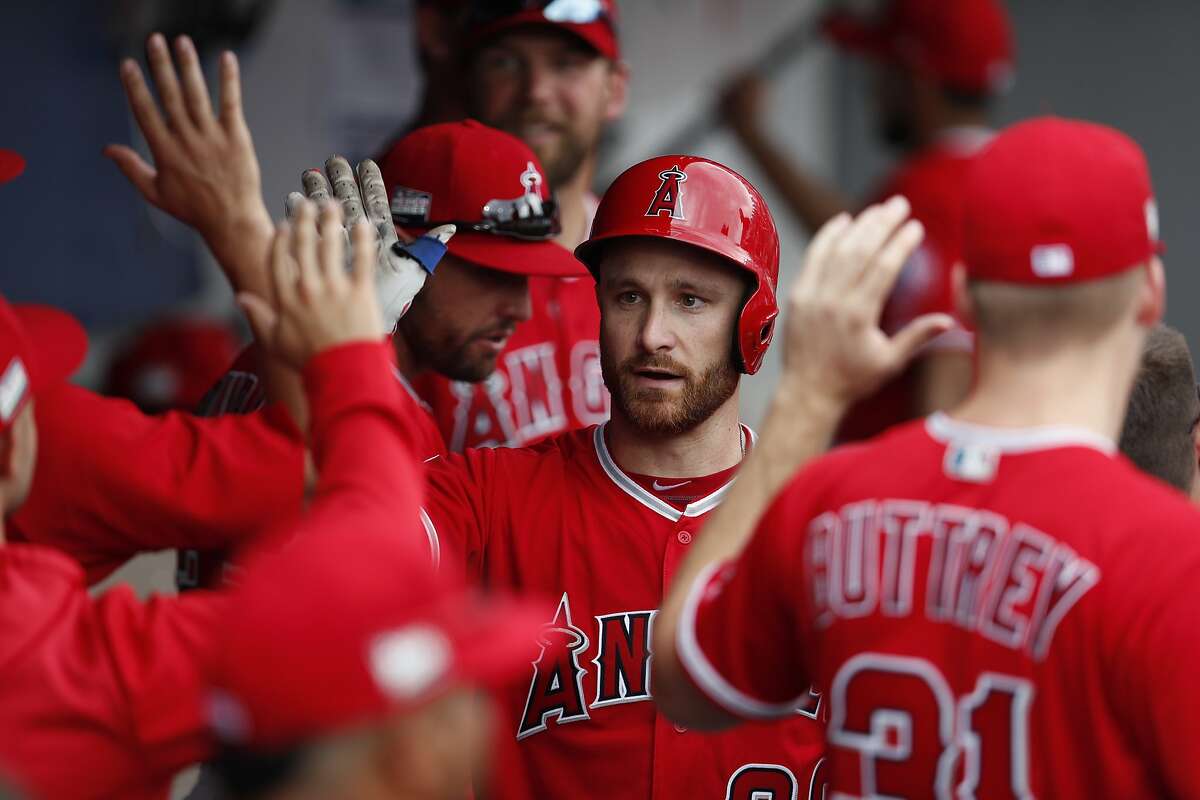Los Angeles Angels' Jonathan Lucroy is congratulated by teammates in the dugout after hitting a home run in the seventh inning of a baseball game against the Houston Astros, in Monterrey, Mexico, Sunday, May 5, 2019. (AP Photo/Rebecca Blackwell)