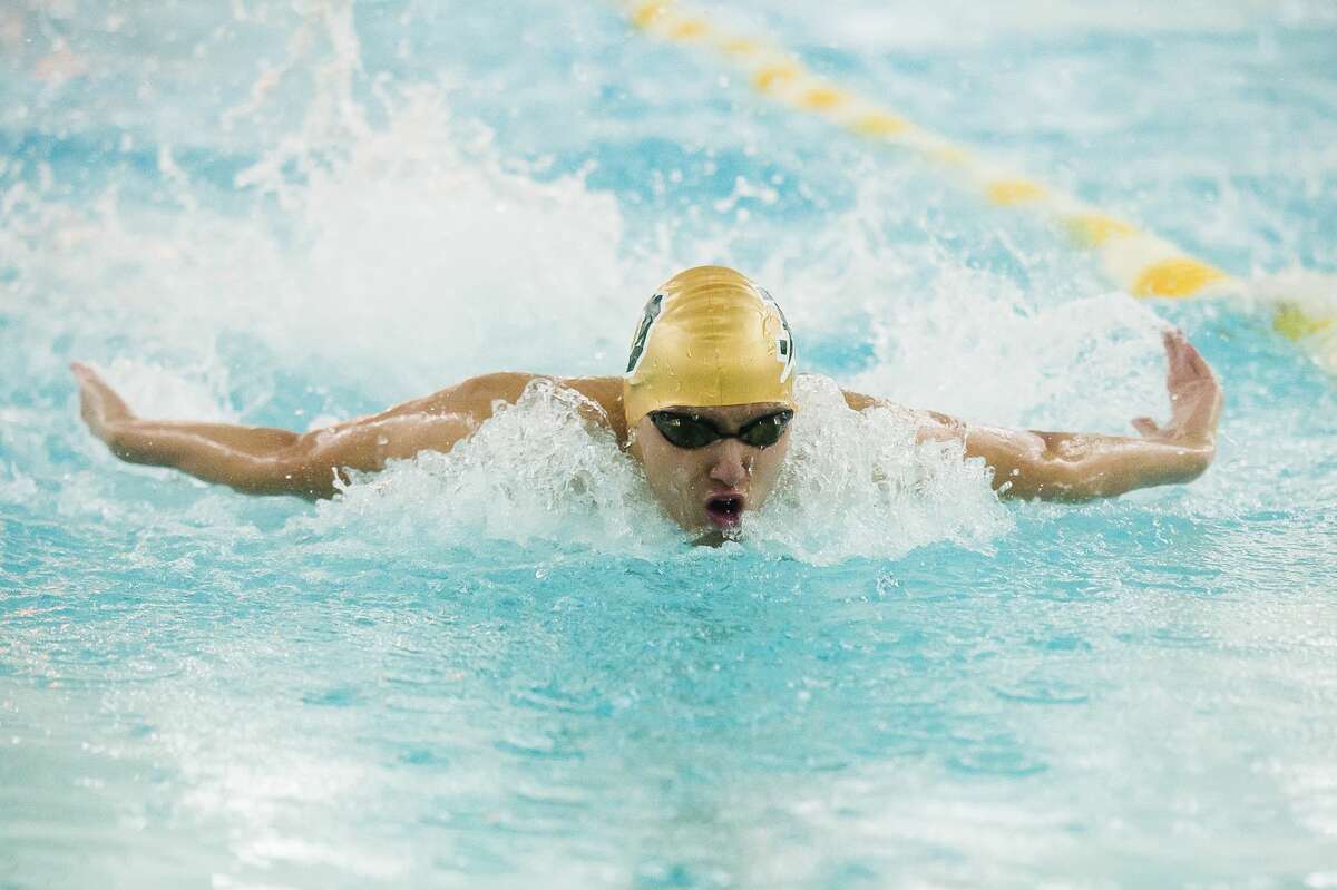 Dow's Collin Che competes in the 100 yard butterfly during a meet against Midland Tuesday, Feb. 11, 2020 at H. H. Dow High School. (Katy Kildee/kkildee@mdn.net)