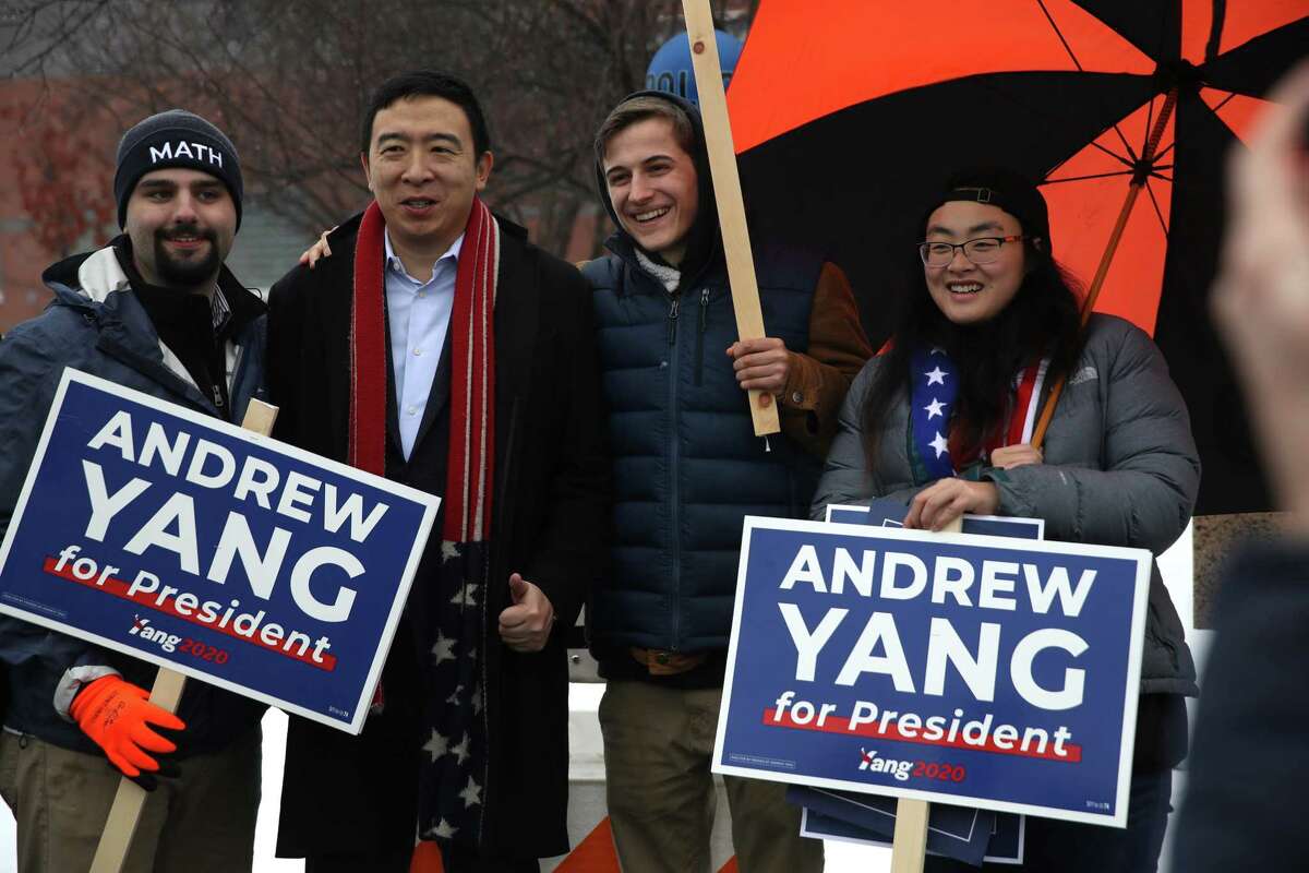 KEENE, NEW HAMPSHIRE - FEBRUARY 11: Democratic presidential candidate Andrew Yang take a photo with supporters who are holding campaign signs in front of a polling station on February 11, 2020 in Keene, New Hampshire. New Hampshire holds its first in the nation primary today. (Photo by Justin Sullivan/Getty Images)