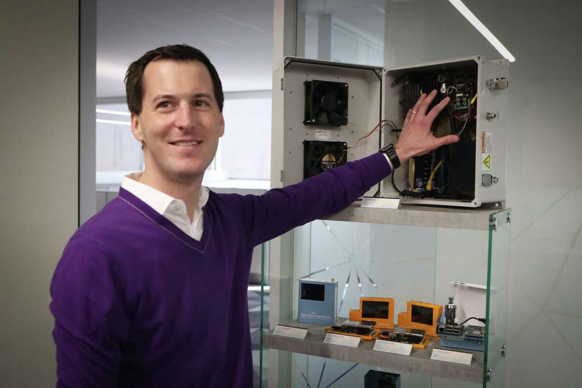 Daniel Baker, the founder and CEO of FlightAware, shows an early version of the company’s ADS-B receivers Tuesday, Jan. 21, 2020, in Houston.