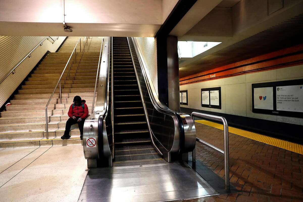 A man sits on the steps at BART Powell Street station in San Francisco, Calif., on Tuesday, February 11, 2020.