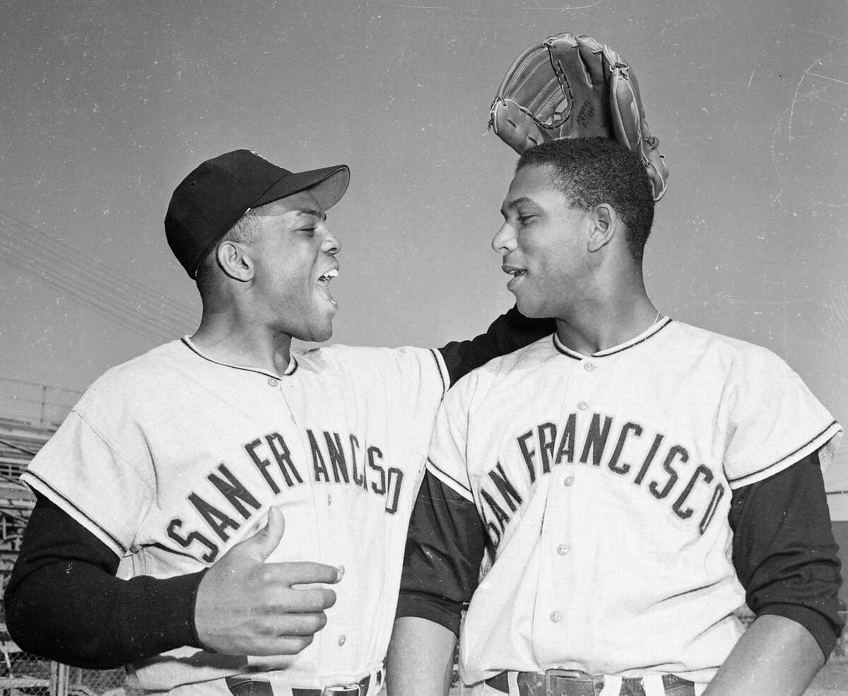 (Original Caption) A pat on the head from outfielder Willie Mays, (L), greets San Francisco Giants first baseman Orlando Cepeda as the latter reported for his first workout at the Giants spring training camp here.