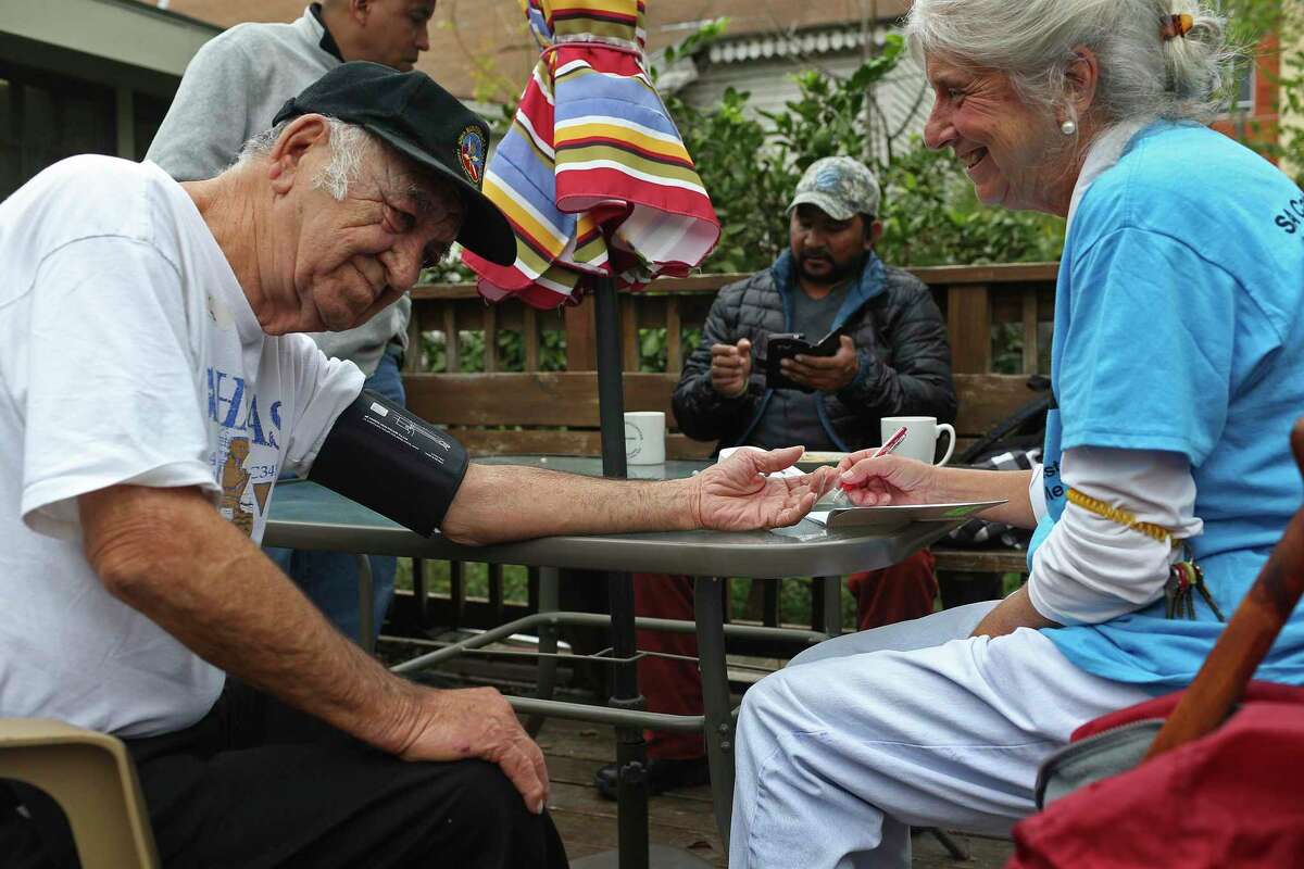 Retired pediatrician Dr. Chris Plauche, right, checks Adolfo Lopez’s blood pressure at the Catholic Worker House located at 626 Nolan Street in December 2015. The house provides a safe place for the homeless and provides breakfast and lunch from Monday through Friday, among other services. It’s one of the entities listed in the new San Antonio Community Resource Directory online at sacrd.org