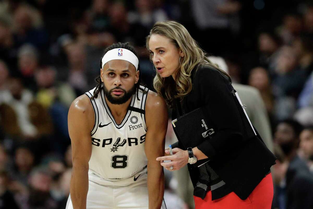 San Antonio Spurs guard Patty Mills (8) talks with assistant coach Becky Hammon during the second half of an NBA basketball game against the Charlotte Hornets in San Antonio, Saturday, Feb. 1, 2020. San Antonio won 114-90. (AP Photo/Eric Gay)