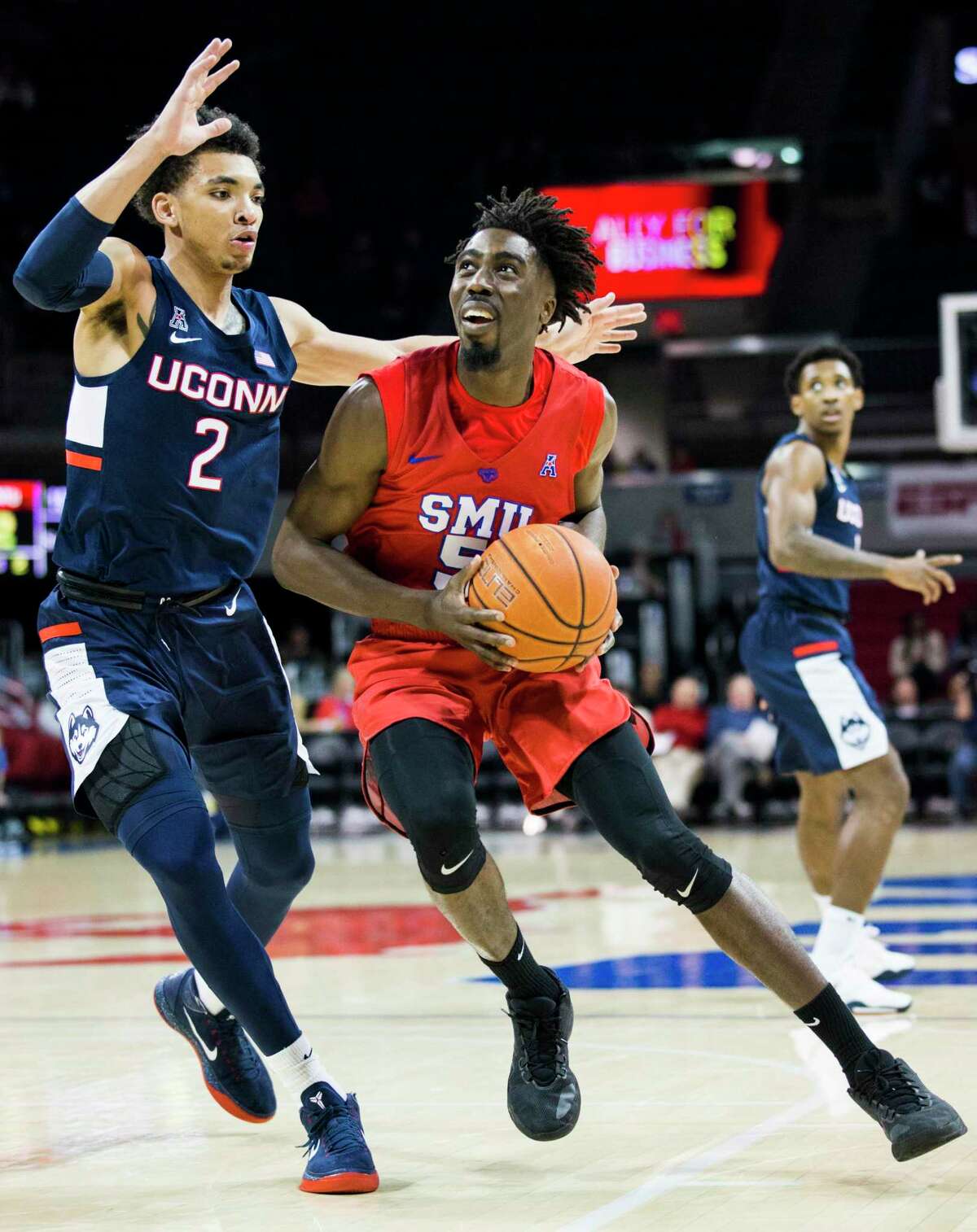 SMU guard Emmanuel Bandoumel (5) looks for a shot around UConn’s James Bouknight (2) during the first half Wednesday in Dallas.
