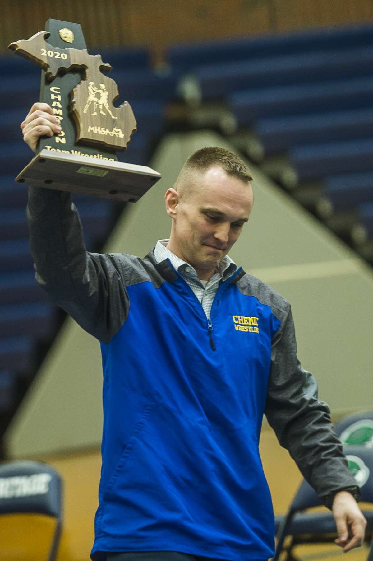 Midland High Wrestling Coach Michael Donovan holds up the chemics' trophy after their Div. 1 district championship win Wednesday, Feb. 12 at Heritage High School in Saginaw. (Katy Kildee/kkildee@mdn.net)
