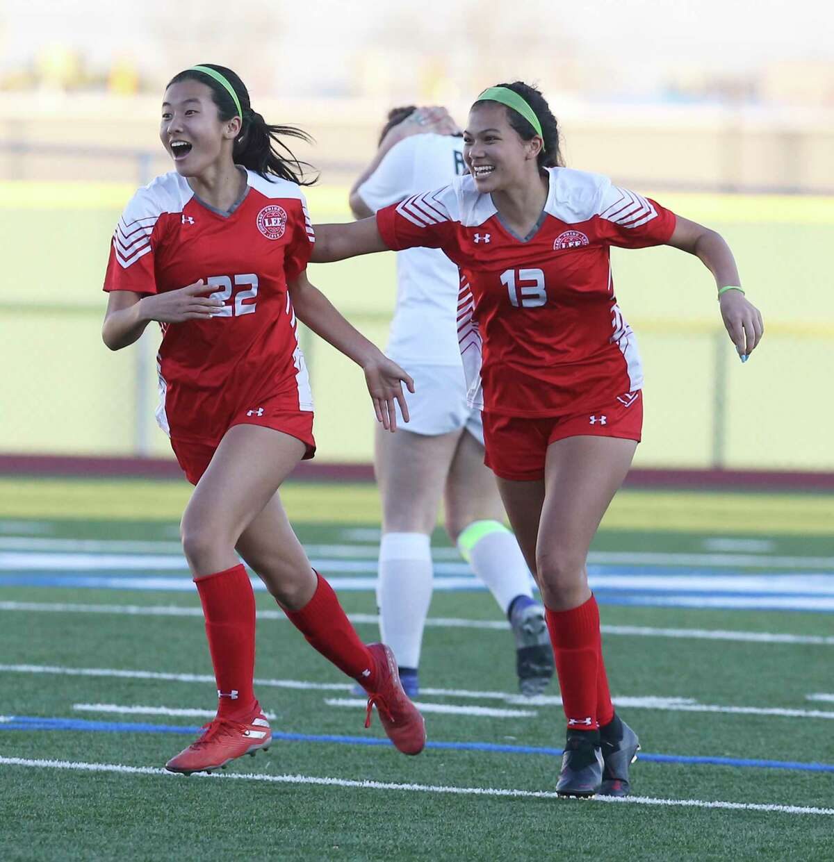 LEE's Kyleena Xin (22) celebrates with teammate Isela Zertuche (13) after Xin scores in the second half against Reagan during their girls soccer game at Commander Stadium on Wednesday, Feb. 12, 2020. LEE defeated Reagan, 1-0, on Xin's score.