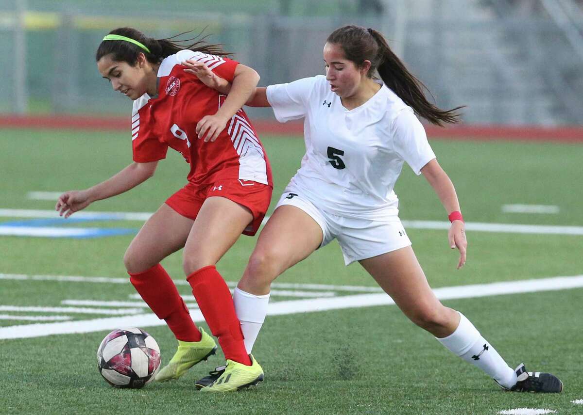 LEE's Victoria Castanon (09) battles with Reagan's Alexa Vela (05) for the ball during their girls soccer game at Commander Stadium on Wednesday, Feb. 12, 2020. LEE defeated Reagan, 1-0.