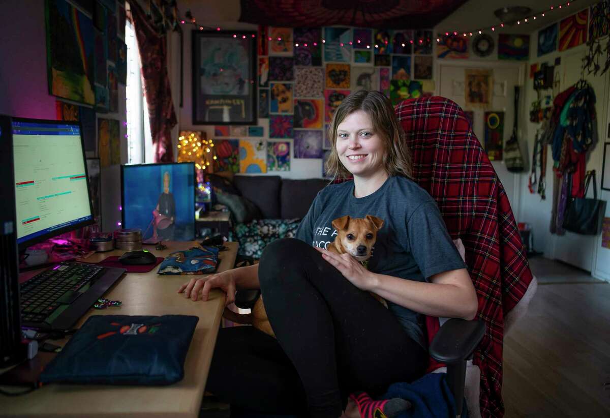 Jess Faerman has gone to great lengths to create a calm, soothing space for herself inside her apartment, Thursday, Feb. 6, 2020, in Houston. Faerman works from home from an extremely comfortable computer chair designed for computer gamers. She also has her pets like Fifi Mae who can jump in her lap.