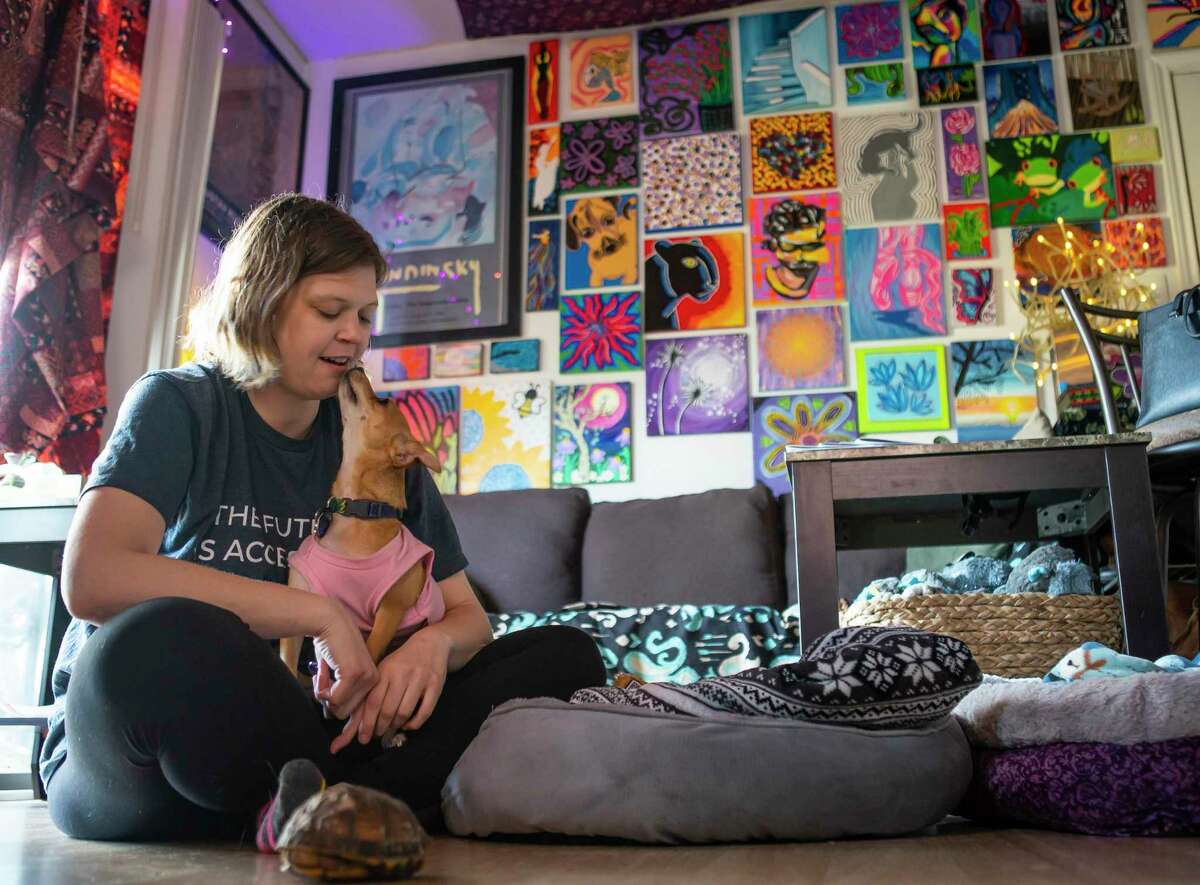 Jess Faerman has gone to great lengths to create a calm, soothing space for herself inside her apartment, Thursday, Feb. 6, 2020, in Houston. Faerman has several pets including two dogs, a turtle and fish.