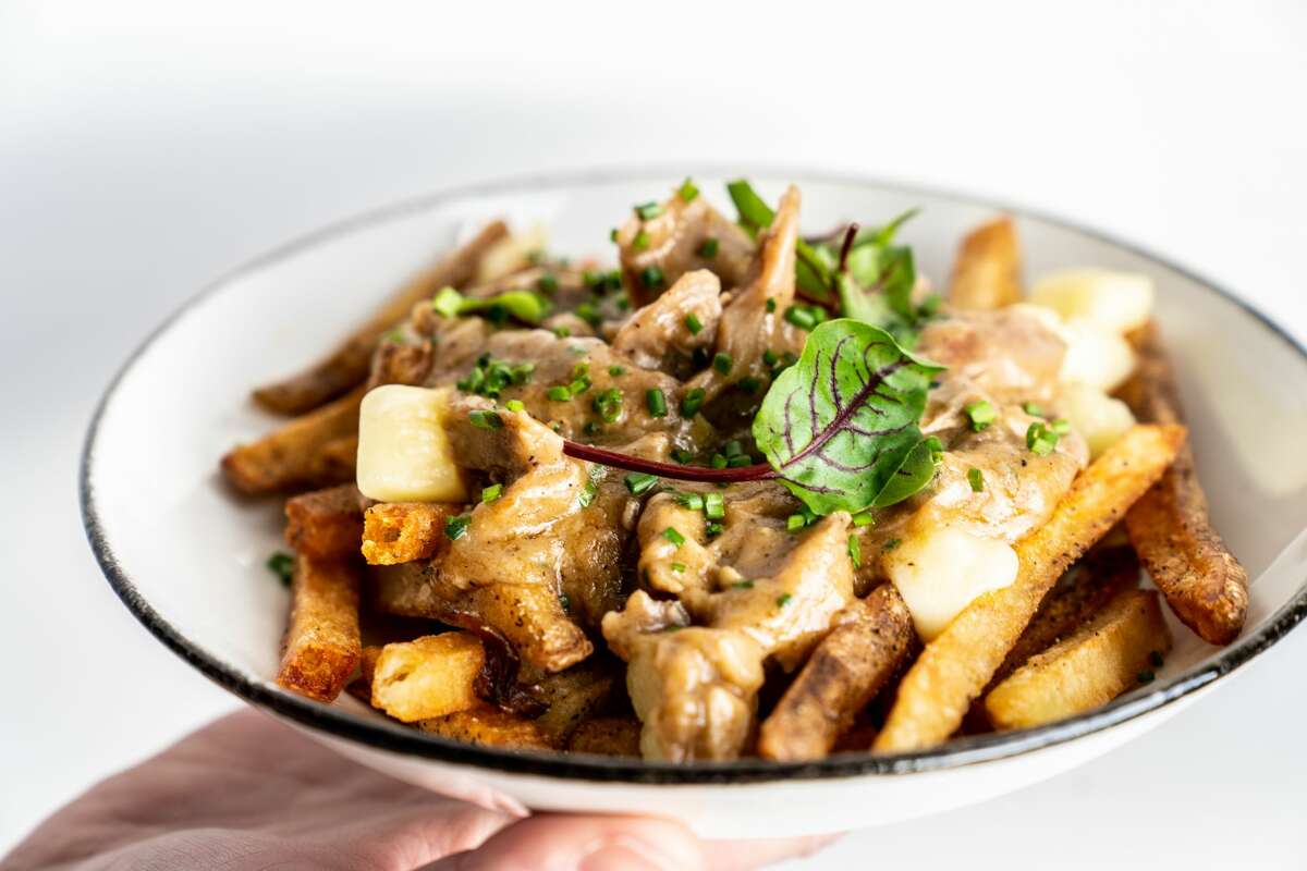Local Group Brewing is set to open at 1504 Chapman in Near Northside on Feb. 28, 2020, according to a Thursday release. Pictured: Duck confit poutine at Local Group Brewing.
