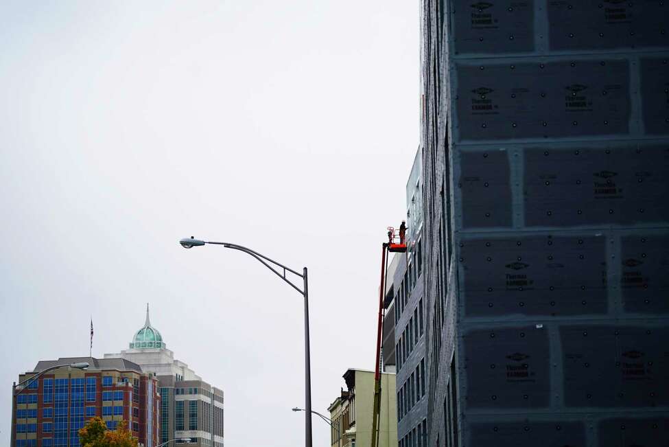 A worker is seen on a construction lift at the site of the 760 Broadway Apartments being built on Monday, Oct. 21, 2019, in Albany, N.Y. (Paul Buckowski/Times Union)