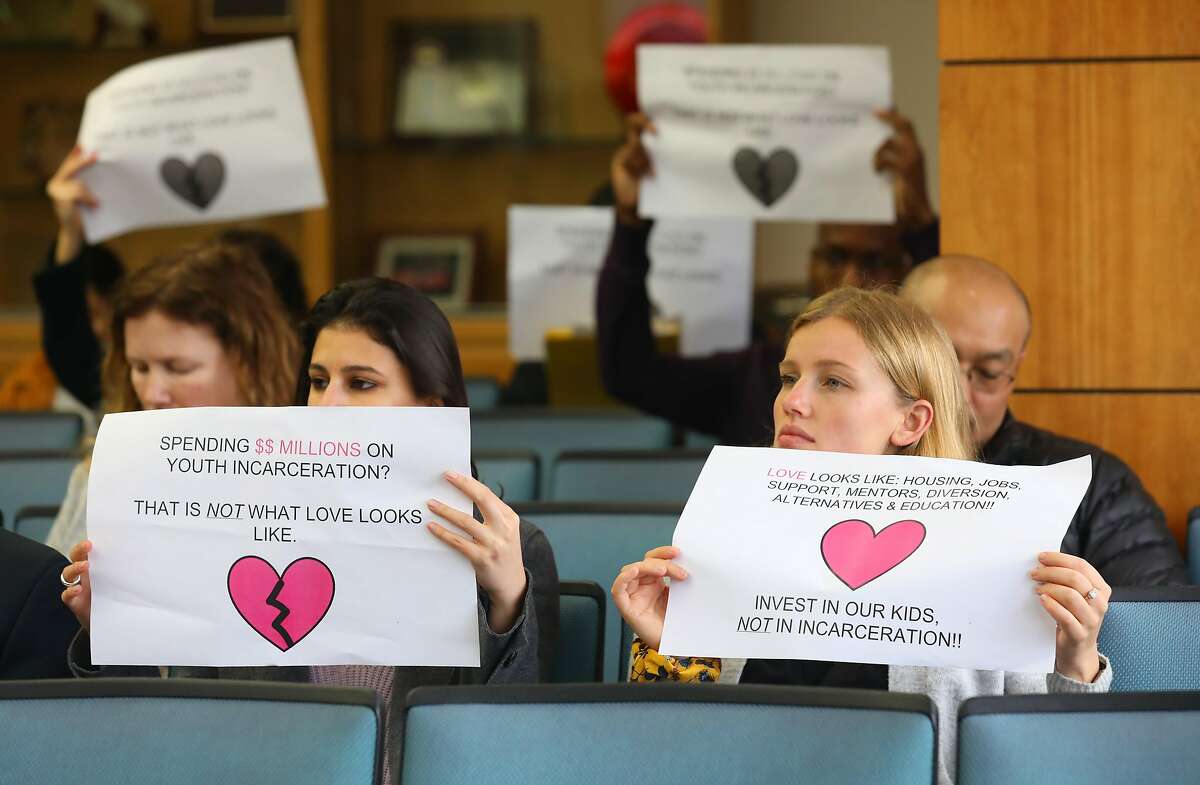 Attendees protest at the supervisor�s meeting at the Alameda County administration building to show opposition for plans to spend $75 million to rebuild its juvenile probation camp, Camp Sweeney, on Thursday, Feb. 13, 2020, in Oakland, Calif.