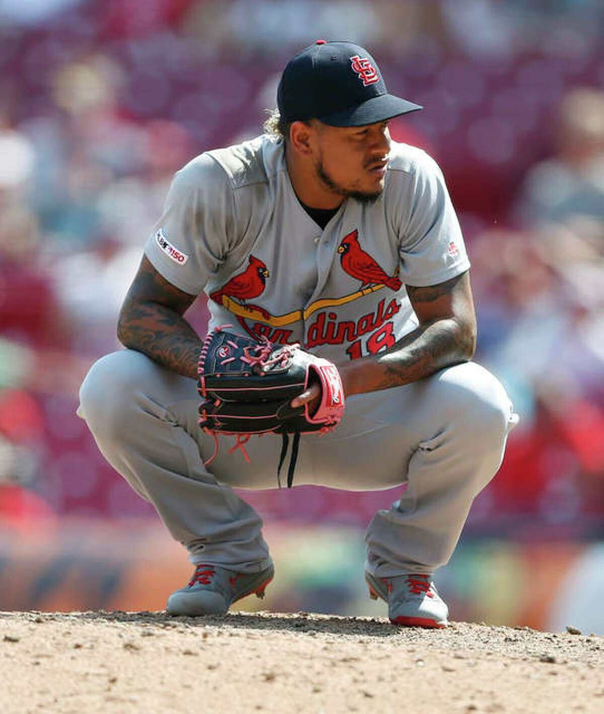 Cardinals closer Carlos Martinez crouches on the mound during a game against the Cincinnati Reds lst season.