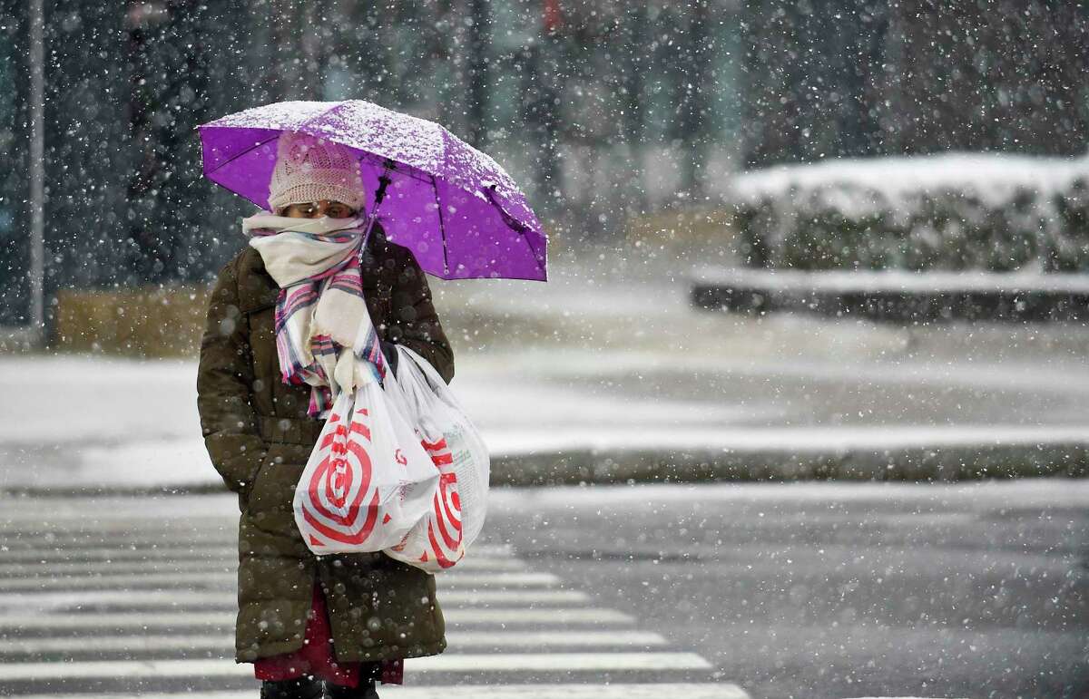 A woman bundled up from falling snow of a winter storm as she crosses Broad Street in downtown Stamford, Conn. on Dec. 9, 2017. What’s causing this wild weather? There are a number of weather systems in play. The remnants of Tropical Storm Zeta will approach today and pass south and east of the area this evening, the National Hurricane Center  says. A secondary coastal low will quickly follow on its heels later tonight into Friday morning. Strong high pressure will quickly build Friday night and settle over the area on Saturday.  
