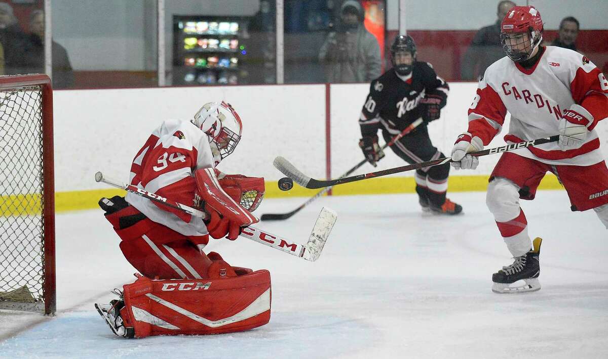 Greenwich goalie Charlie Zolin makes a save in front of the net against New Canaan in an FCIAC game at Dorothy Hamill Ice Rink in Greenwich in February.