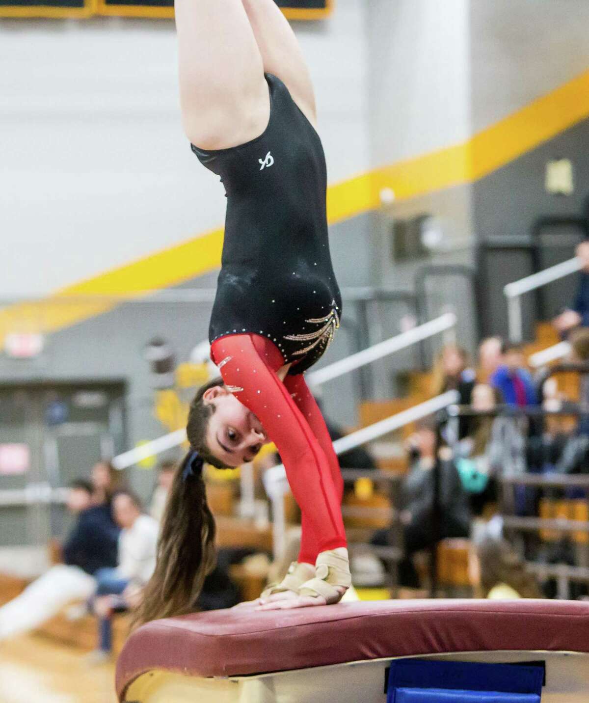 Branford’s Brooke Kustra competes in the vault during the SCC gymnastics championship on Thursday.