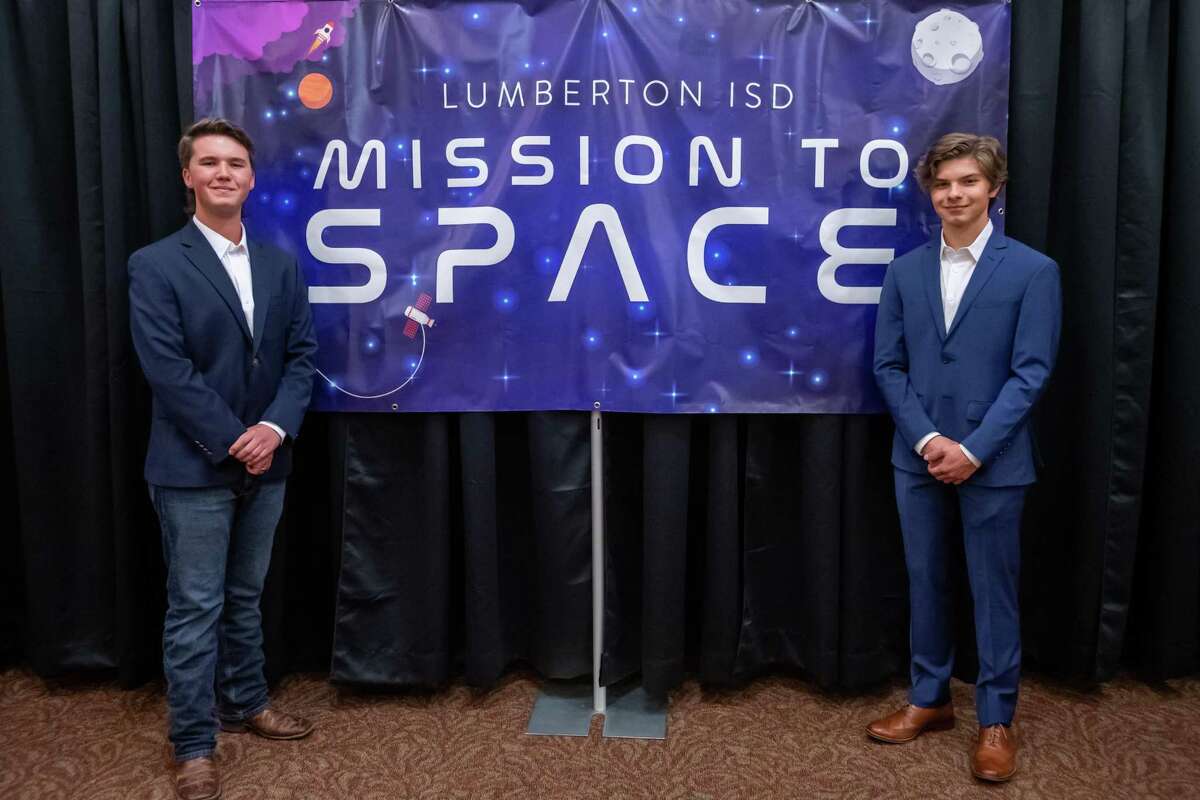 Austin Howard, left, and Lucas Mason stand by the Mission To Space banner in the school's performing arts center. The two students from Lumberton High School won a competition to send an experiment to the international space station this summer as part of the Student Spaceflight Experiments Program and the LISD held a night to honor them on February 13, 2020. Fran Ruchalski/The Enterprise