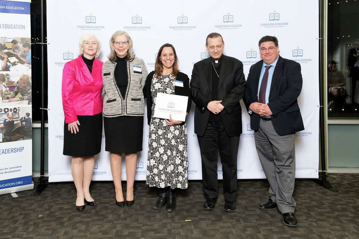Shelia Krawitz, center, with, left to right, Holly Doherty-Lemoine, HTCA Head of School Lisa Lanni, Bishop Caggiano and Dr. Steve Cheeseman, superintendent of schools.