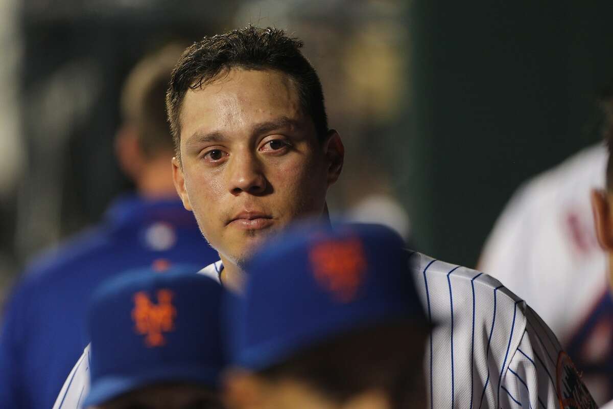 Wilmer Flores, New York Mets, in tears in the dugout after learning he had been traded to the Milwaukee Brewers during the New York Mets Vs San Diego Padres MLB regular season baseball game at Citi Field, Queens, New York. USA. 29th July 2015. Photo Tim Clayton (Photo by Tim Clayton/Corbis via Getty Images)