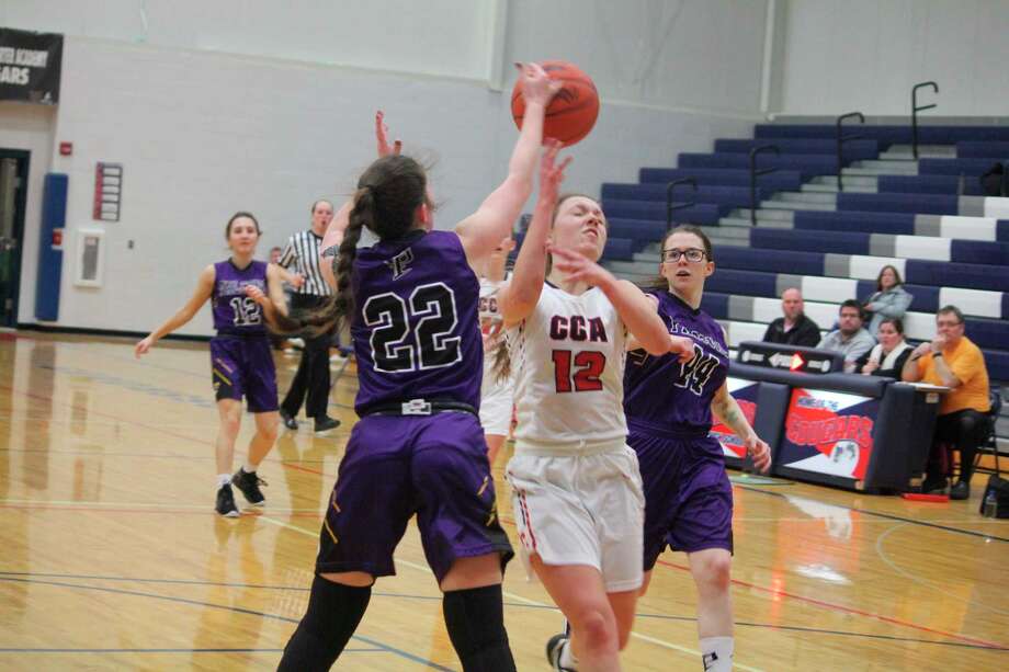 Crossroads' Allie Angell (12) battles for the ball against Pentwater's Mika Hugo (22) on Thursday. (Pioneer photo/John Raffel)