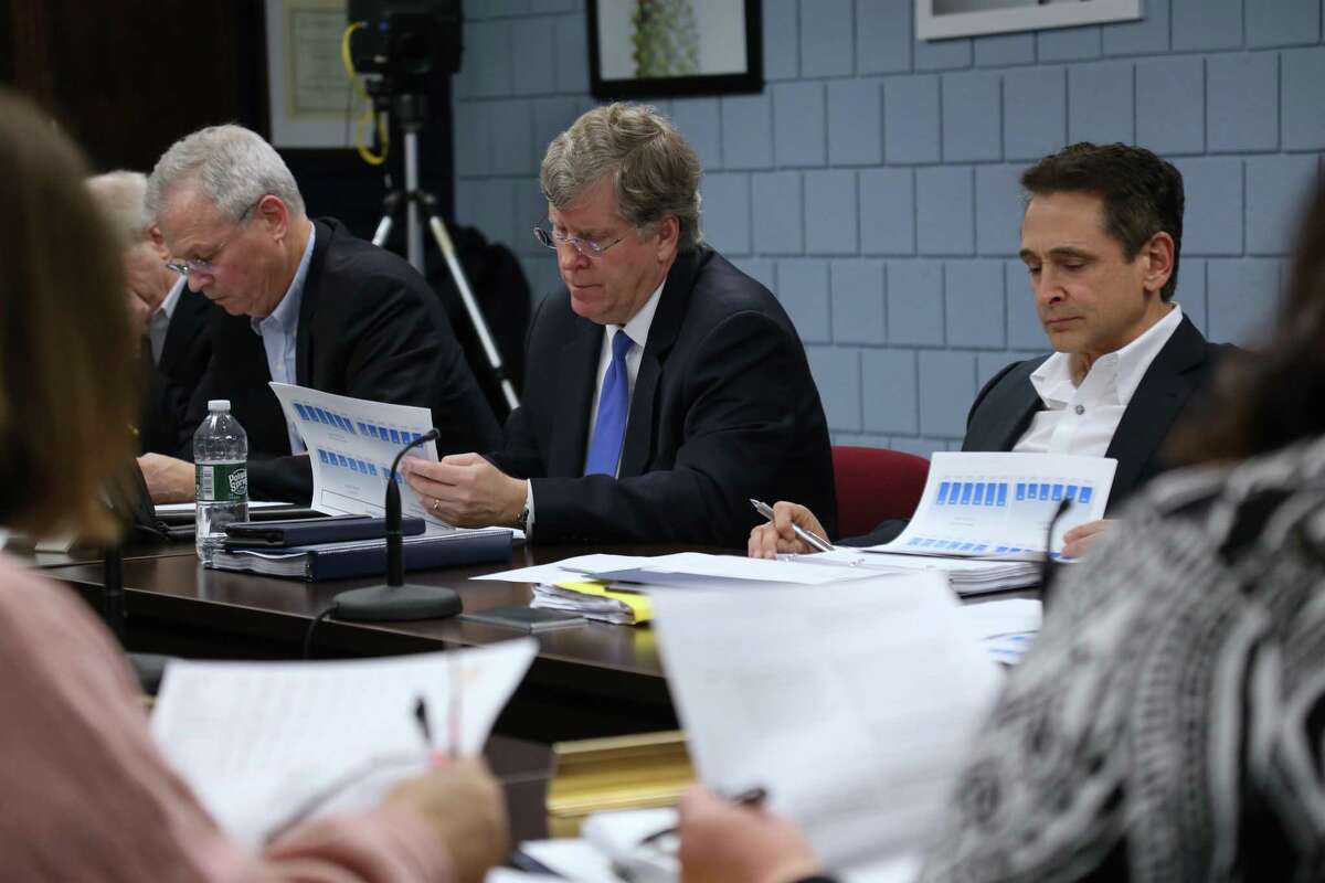 Before the pandemic changed everything, Board of Finance members Jeff Rutishauser, Michael Kaelin and Stewart Koenigsberg look over Board of Education documents on Feb. 6.
