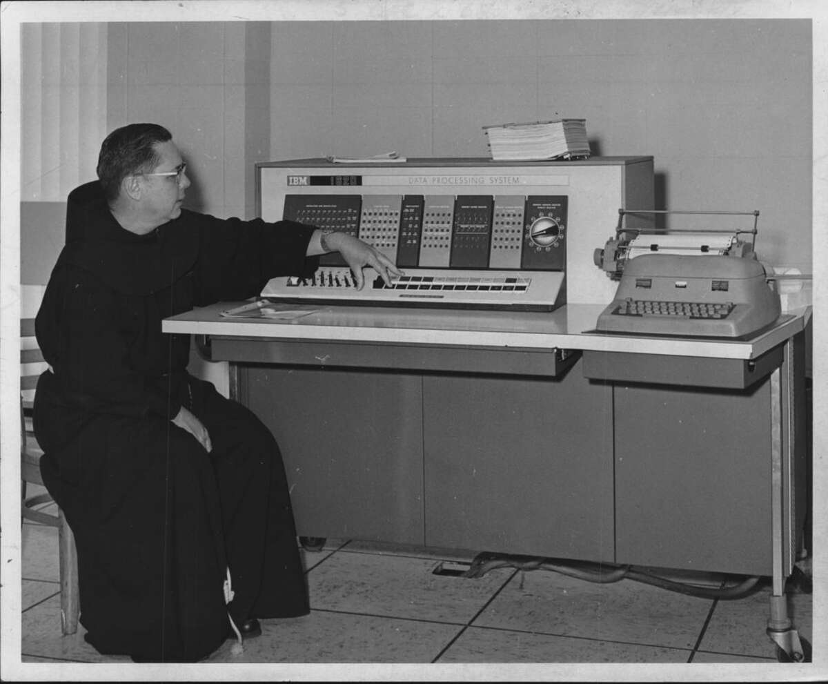 The Rev. Laurence Rainville works the IBM 1620 data processing system in Siena College's new computer laboratory in Roger Bacon Hall on the campus in Loudonville in 1967. The computer was used for all programming instruction and was also available to professors of the science division for research work. Students who completed the programming course were also free to use the computer.