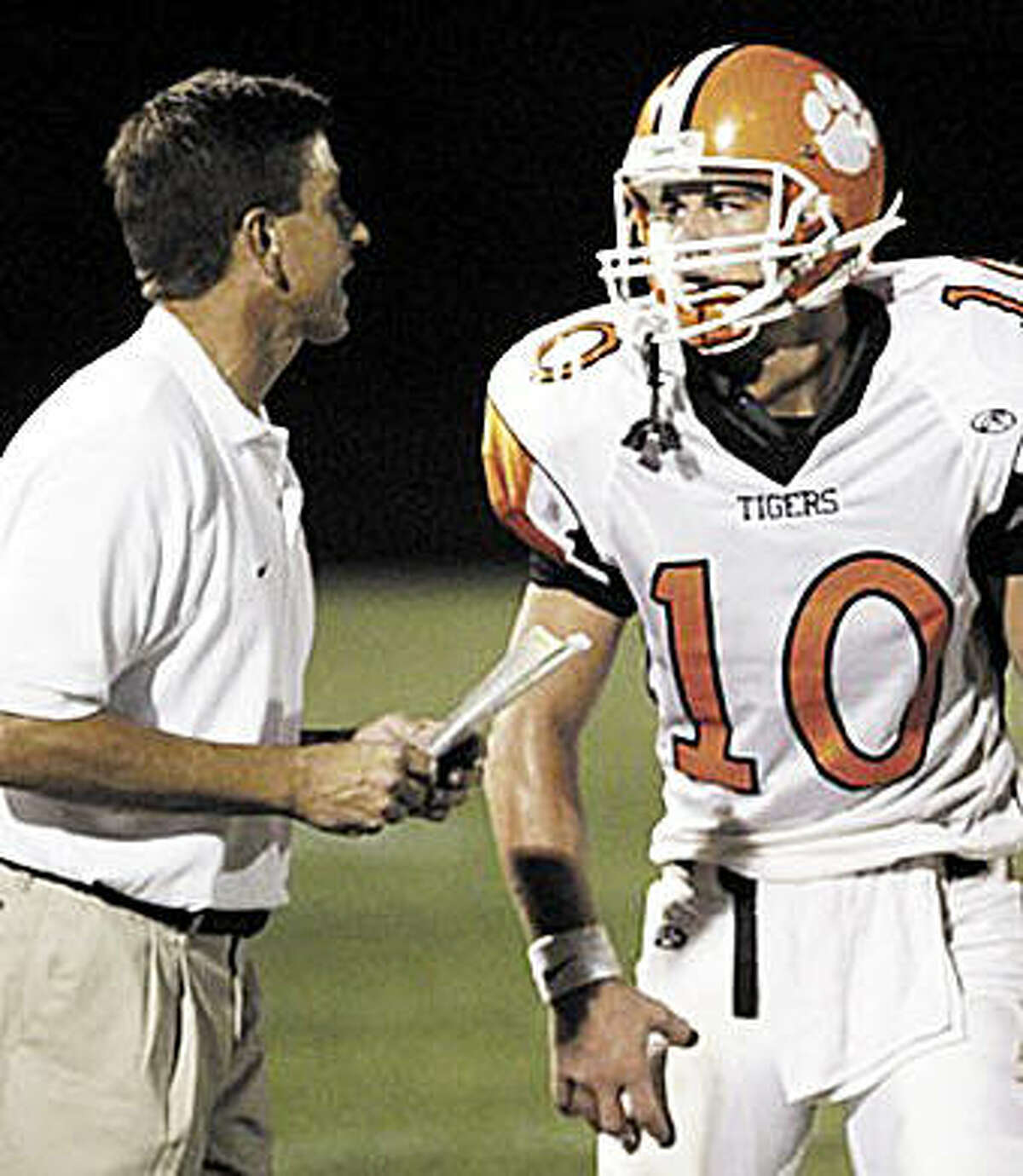 Former Edwardsville coach Tim Dougherty, left, talks to EHS quarterback Joe Allaria during a game in 2006. Dougherty, who was the head coach at EHS from 1992 to 2007, is currently an assistant coach and defensive coordinator at Hamilton High School in Chandler, Arizona.