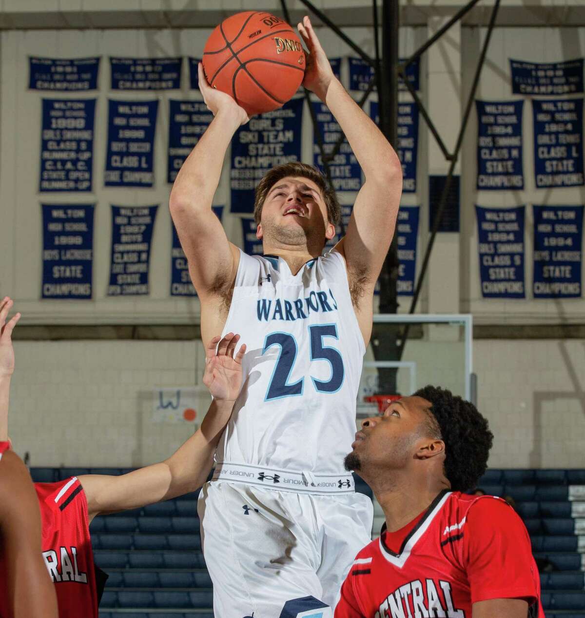 Kyle Hyzy (shown in a recent game against Central) scored 25 points as Wilton defeated Trumbull, 73-69, on Thursday night.