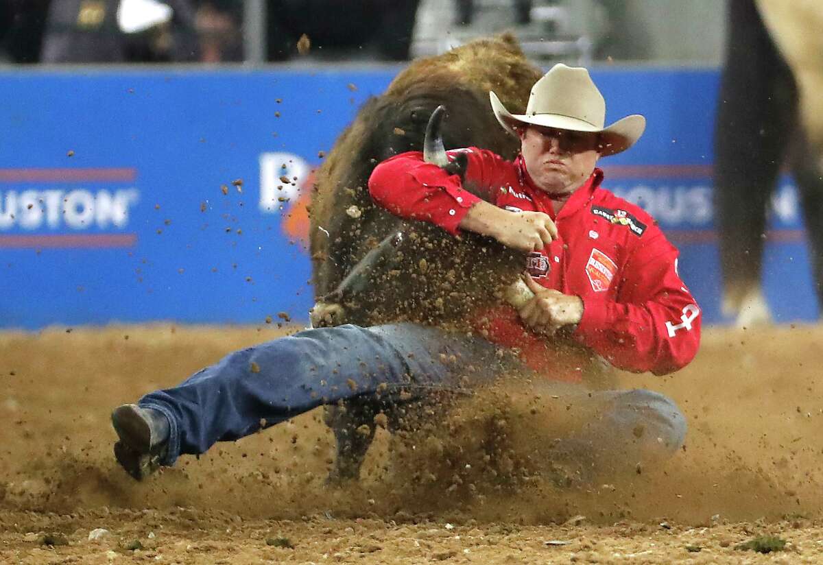 Tyler Waguespack brings down his steer during steer wrestling competition during RodeoHouston Semifinal 2 at NRG Stadium on Thursday, March 14, 2019, in Houston.