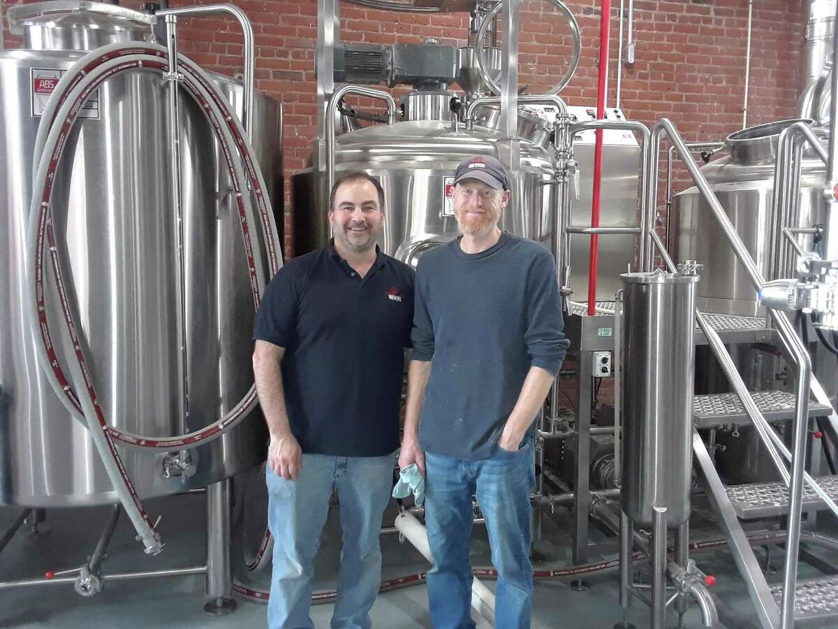 Nils Johnson, left, and brewmaster Nate Day, co-founded and own Little Red Barn Brewers, along with Day’s brother Matt.
