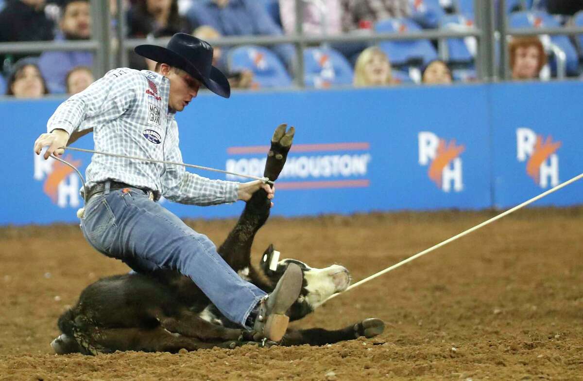 Tuf Cooper ropes his calf as he take the lead in the tie down roping competition during RodeoHouston Wild Card round at NRG Stadium on Friday, March 15, 2019, in Houston.