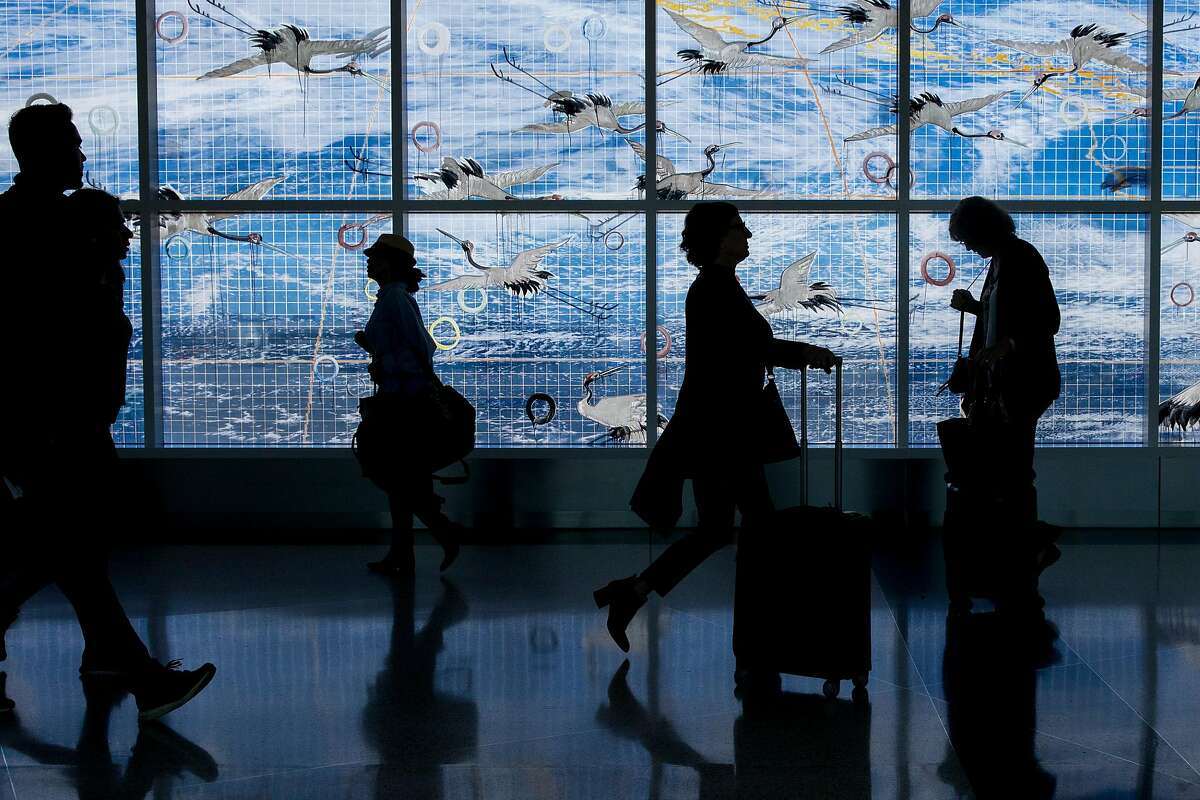Travelers are silhouetted against a window art installation called Going Away, Coming Home by Hung Liu while making their way through Terminal 2 at Oakland International Airport in Oakland, Calif. Thursday, January 30, 2020. The airport has had a year of ups and downs, with large airlines such as Norwegian and JetBlue rerouting away from Oakland and to SFO, but at the same time Southwest has expanded its services out of Oakland to Hawaii, leaving the promise of even more travelers making their way through the terminals of Oakland International Airport.