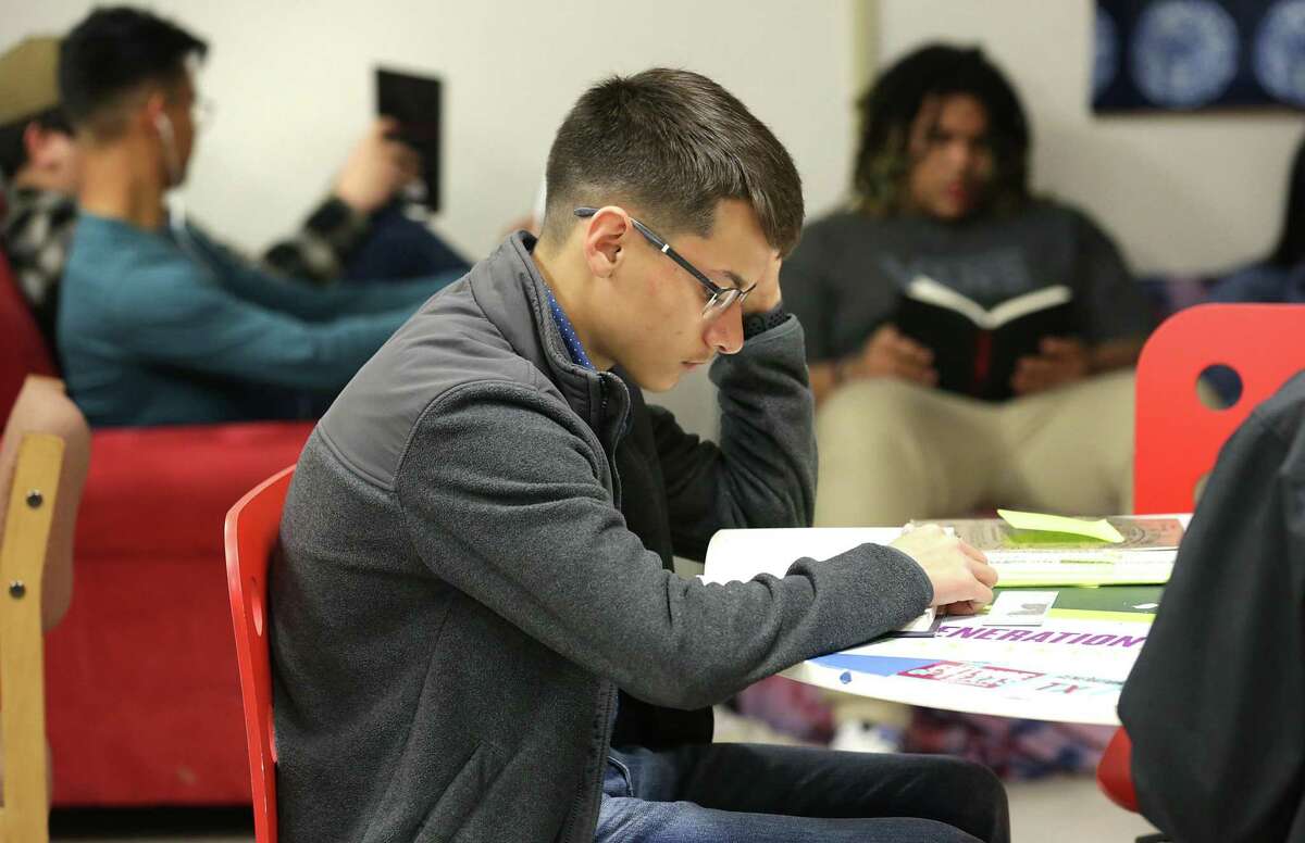 Aaron Melendez, and other students in Michael Guevara’s 10th grade English class at Southwest High School, read. As school districts continue to cut book budgets for libraries, trim staff and close them altogether, teachers such as Guevara are fighting back by creating their own self-curated libraries.