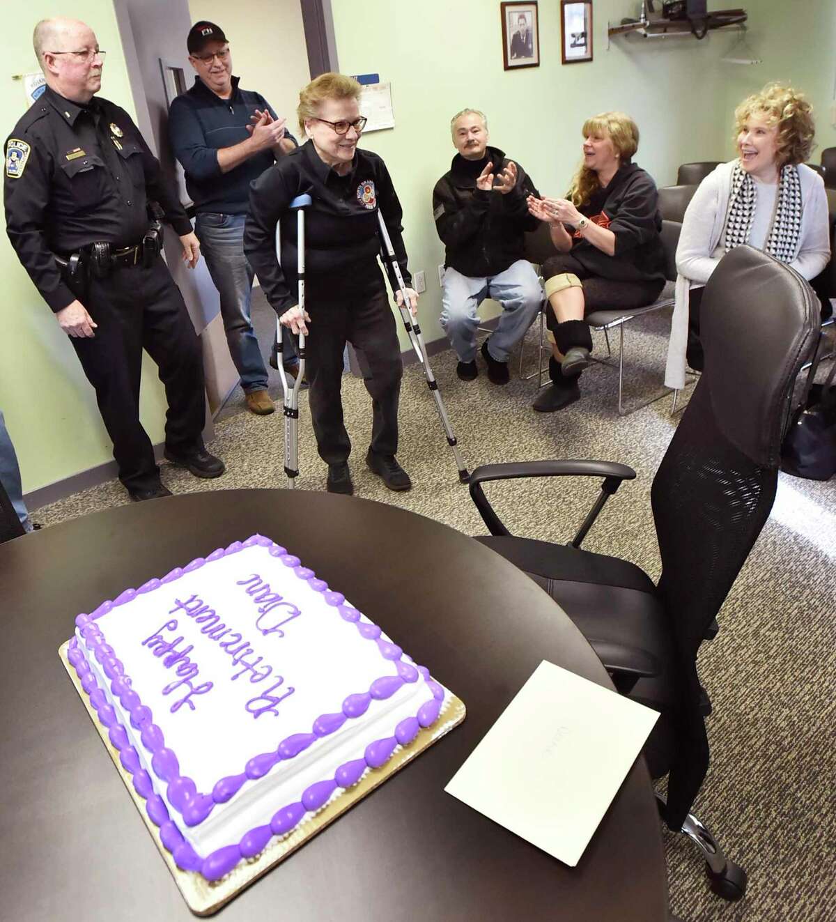 Diane Ramsey of North Branford is walked into a reception on her last day on the job before retiring.