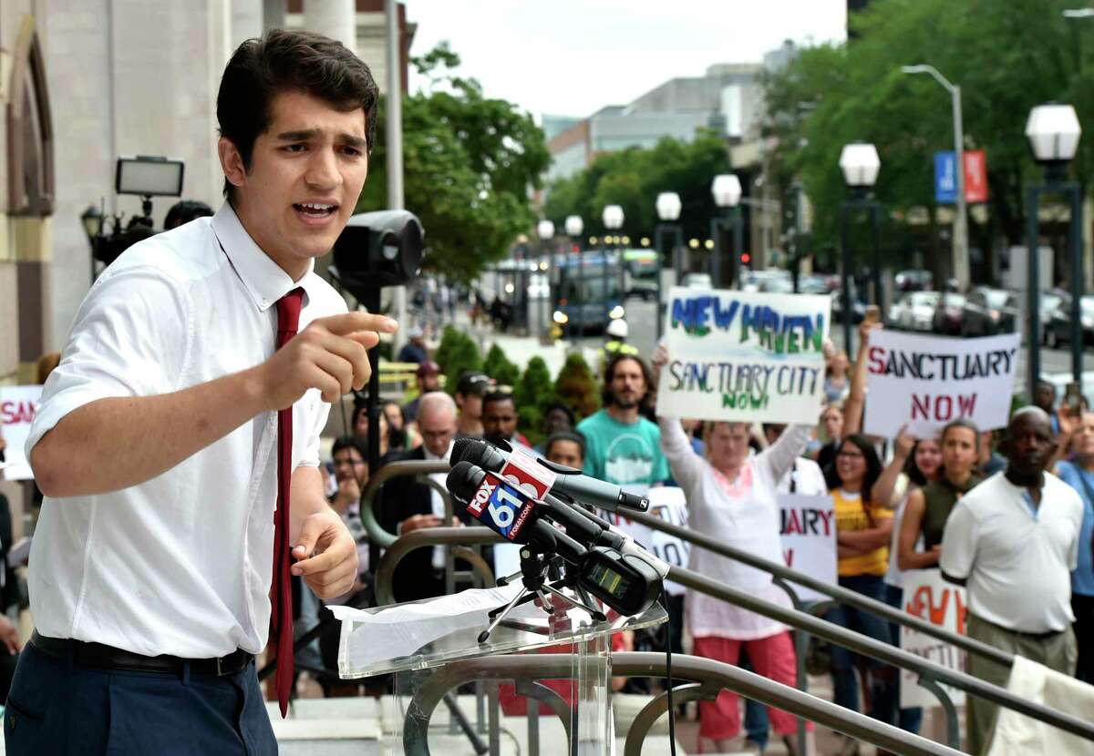New Haven, Connecticut - Wednesday, August 14, 2019: New Haven Ward 1 Alderman Hacibey Catalbasoglu speaks during a rally by Unidad Latina en Accion Wednesday evening at City Hall to start a campaign to push the New Haven Board of Alders to codify a New Haven Sanctuary City Ordinance. Mayor Toni N. Harp also attended the event to detail her Executive order spelling out city policy regarding undocumented immigrants.