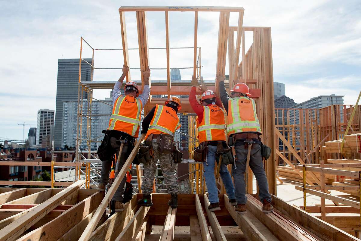 Construction workers hoist a wall onto the facade of an affordable housing development for seniors under construction along the Embarcadero near Broadway in San Francisco, Calif. Tuesday, February 4, 2020. San Francisco Mayor London Breed is planning to spearhead a signature-gathering effort to put a measure on the November 2020 ballot that will make 100% affordable housing developments easier to build. This measure would also confer streamlining benefits to market-rate housing projects that exceed their affordability requirements.