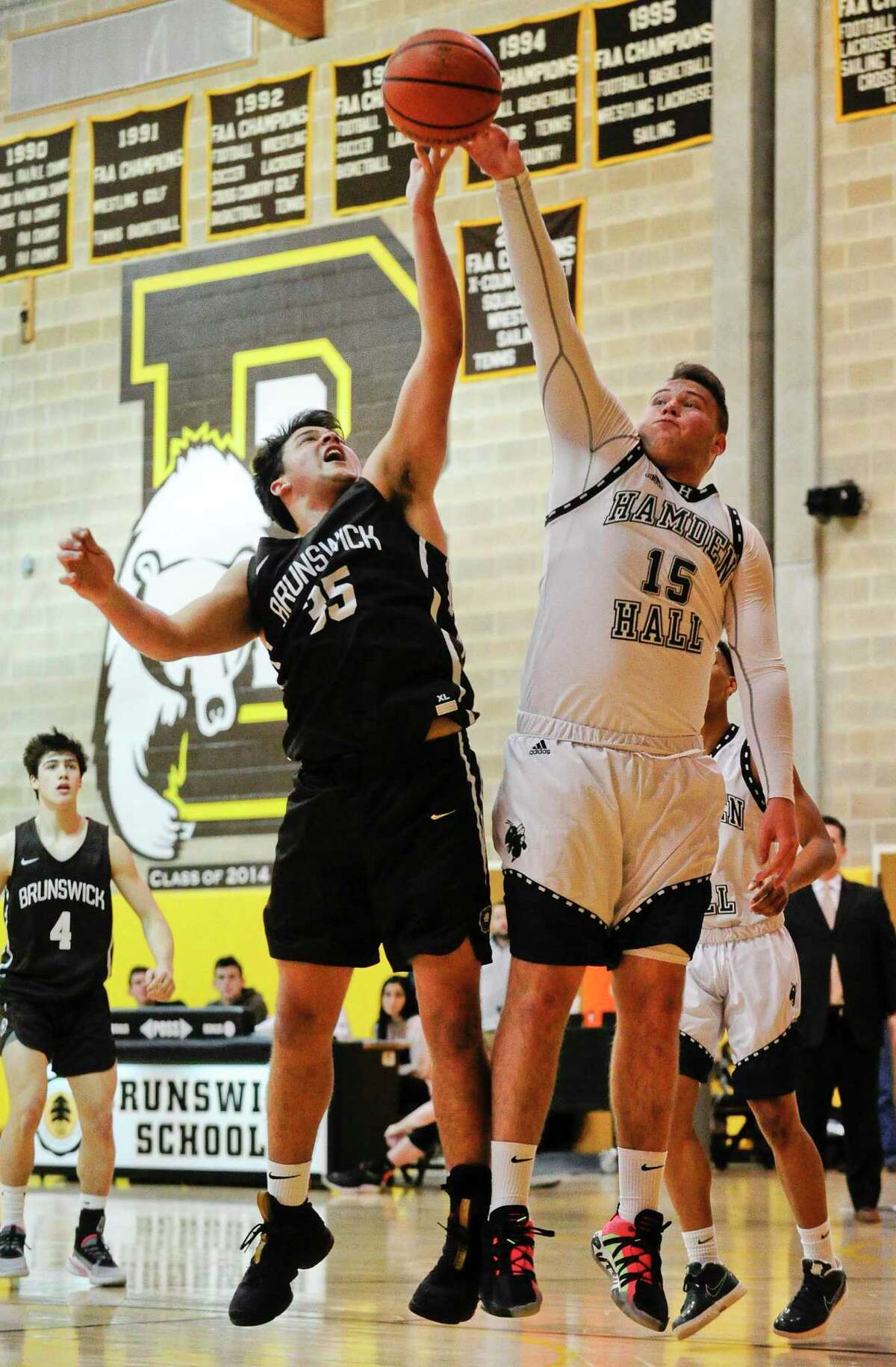 Brunswick's Henry Caponiti (35) and Hamden Hall's Owen MacDonough (15) battle for a rebound in the first half of an FAA boys basketball game at Brunswick School on Feb. 14, 2020 in Greenwich Connecticut. Hamden Hall defeated Brunswick 59-58.