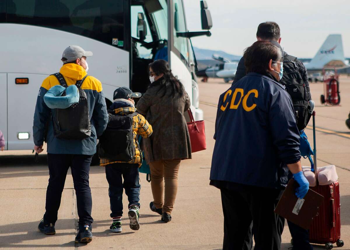 This handout photo released by the US Marine Corps shows evacuees from China arriving at Marine Corps Air Station (MCAS) Miramar, in San Diego, California, on February 5, 2020. - MCAS Miramar worked with the Center for Disease Control (CDC) and Health and Human Services (HHS) for the quarantine of travelers evacuating from China and the Coronavirus outbreak. Authorities in China warned they faced a severe shortage of hospital beds and equipment needed to treat a growing number of patients stricken by the new coronavirus, as the death toll passed 560 on February 6 and cities far from the epicentre tightened their defences. (Photo by Krysten HOUK / US MARINE CORPS / AFP) / RESTRICTED TO EDITORIAL USE - MANDATORY CREDIT "AFP PHOTO / US MARINE CORPS / LANCE CPL. KRYSTEN HOUK " - NO MARKETING - NO ADVERTISING CAMPAIGNS - DISTRIBUTED AS A SERVICE TO CLIENTS (Photo by KRYSTEN HOUK/US MARINE CORPS/AFP via Getty Images)