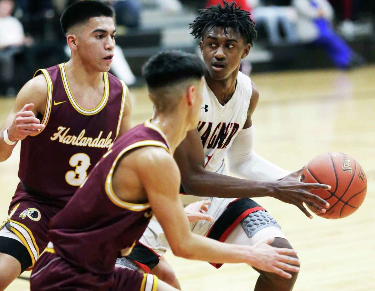 Wagner guard Ja’Sean Jackson draws a double-team at the top of the key and looks for the open man against Harlandale on Feb. 14, 2020.