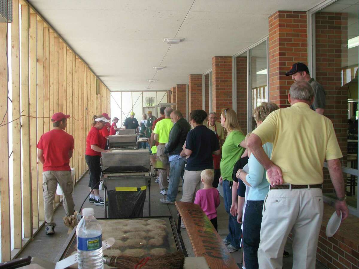 People line up in the plastic enclosure for pancakes during the 2012 Pancake Supper. (Photo courtesy of Ruby Iwamasa)