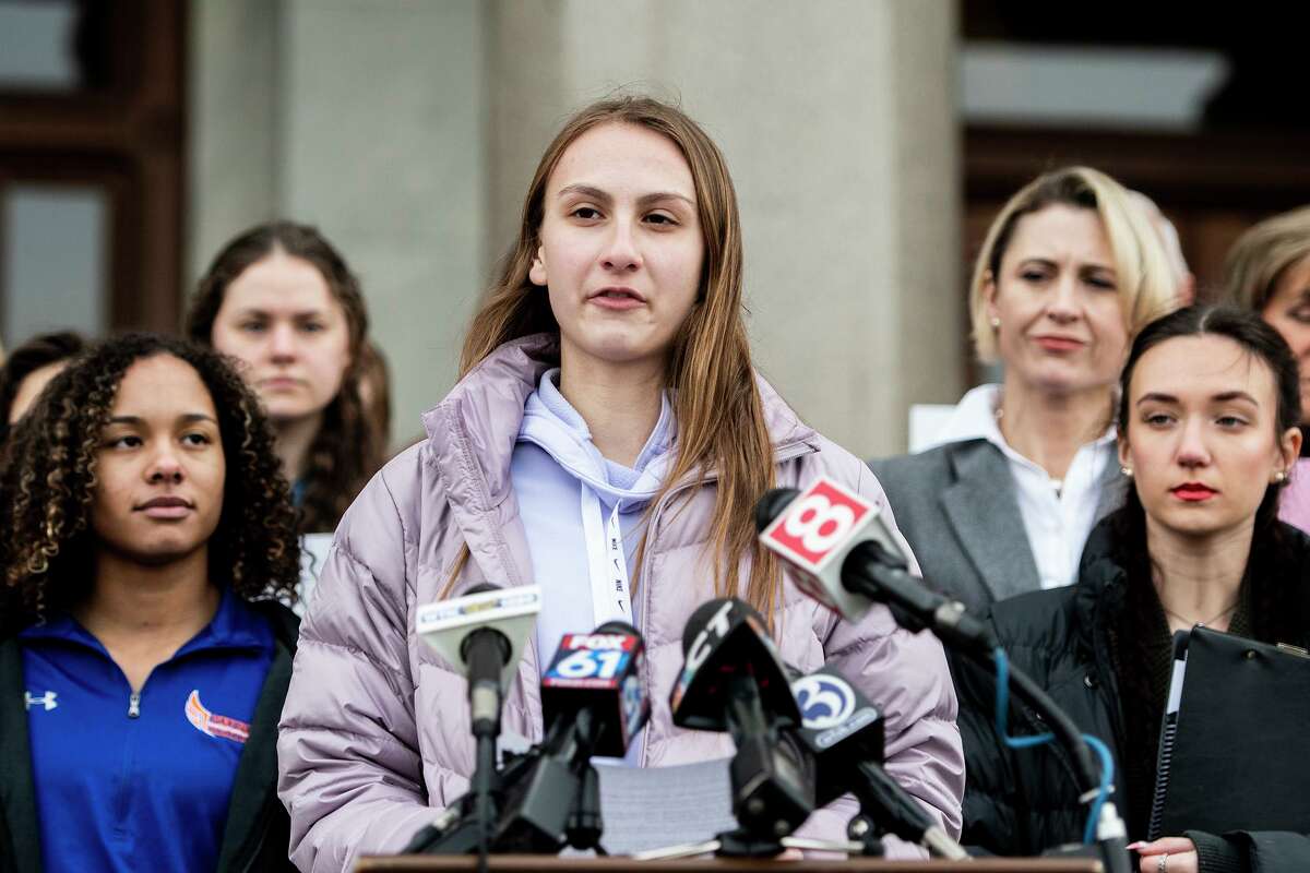 Canton High School senior Chelsea Mitchel speaks during a press conference with Alanna Smith, Danbury High School sophomore, to her left and Selina Soule, Glastonbury High School senior, to her right at the Connecticut State Capitol Wednesday, Feb. 12, 2020, in downtown Hartford, Conn.