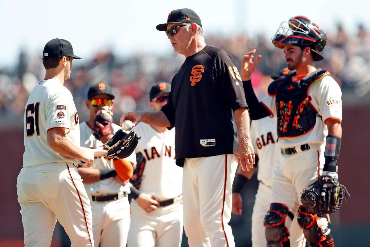 San Francisco Giants' manager Bruce Bochy gives the ball to Burch Smith after Tyler Beede was injured in 4th inning against Colorado Rockies during MLB game at Oracle Park in San Francisco, Calif., on Thursday, September 26, 2019.