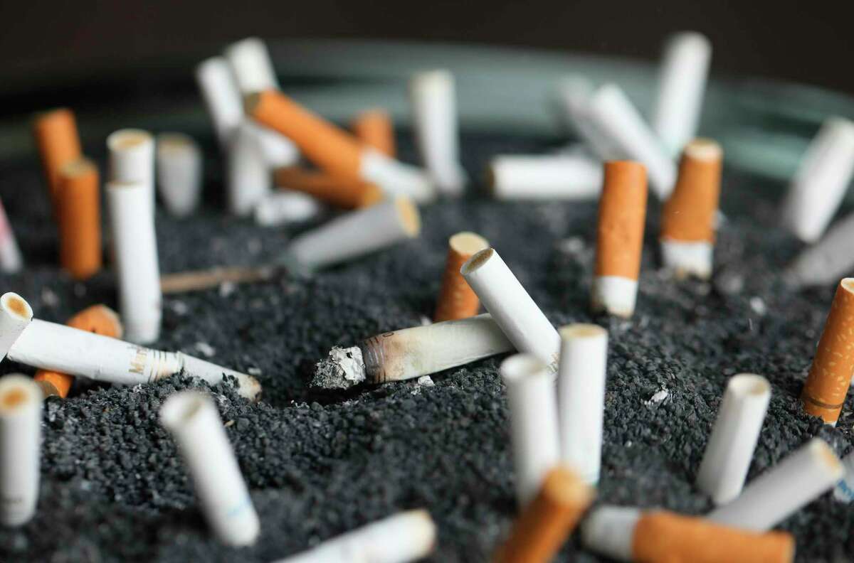 FILE - This March 28, 2019, file photo shows cigarette butts in an ashtray in New York. Moving company U-Haul has a new hiring policy and smokers need not apply. Starting this month the company will screen out people who use tobacco or nicotine when making new hires in certain U.S. states. (AP Photo/Jenny Kane, File)