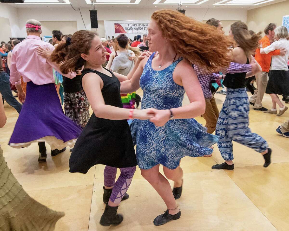 Cricket and Una Liebermann of Vermont dance during the annual Flurry Festival at the Saratoga City Center in Saratoga Springs in February 2020. The 35-year-old festival, among the largest celebrations of folk dance and music in the nation, is facing a financial crisis.
