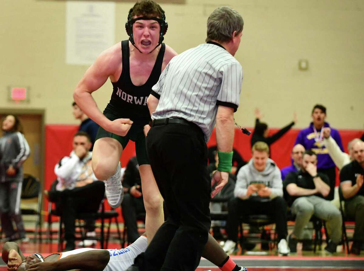 Norwalk’s Brendan Gilchrist celebrates against Danbury’s Tyrell Jones of Danbury in the 182 pound division at the FCIAC championship on Saturday.