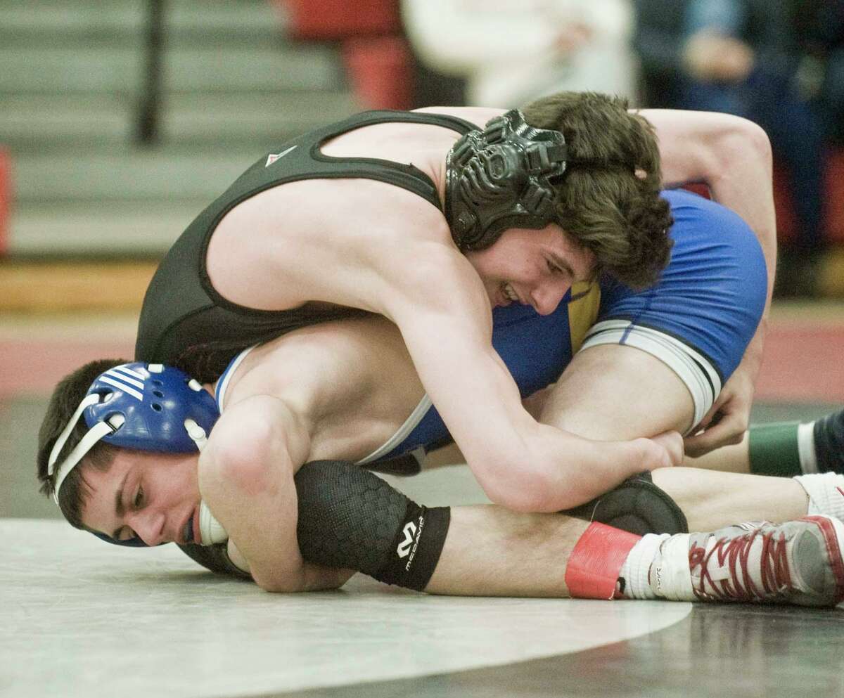 Brookfield’s Matty Carrozza maneuvers under Pomeraug’s Joey Mastroianni in the 113-pound match of the SWC championships at Pomperaug on Saturday.